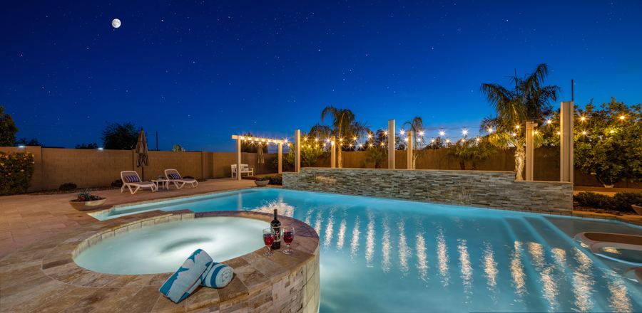 Pool and spa under string lights at night, Family Focused in Gilbert, AZ