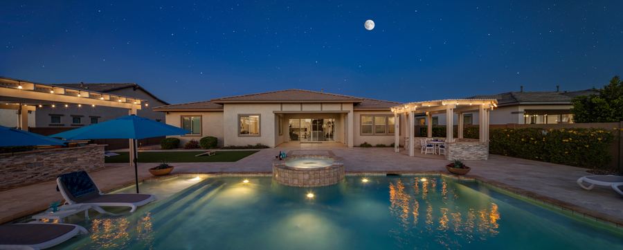 Pool and home at night under the moon