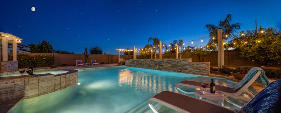 Pool and lounge chairs at night