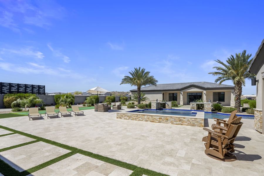 Travertine deck with turf ribbons and spa, Legacy Living in San Tan Valley, AZ