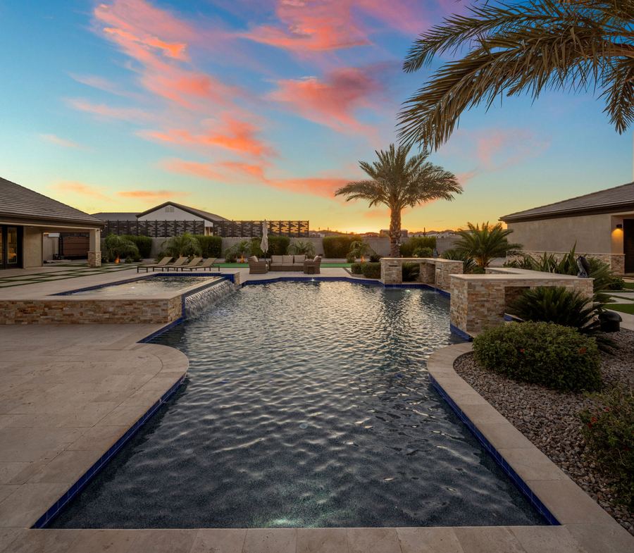 Long view down the pool to the raised spa at sunset