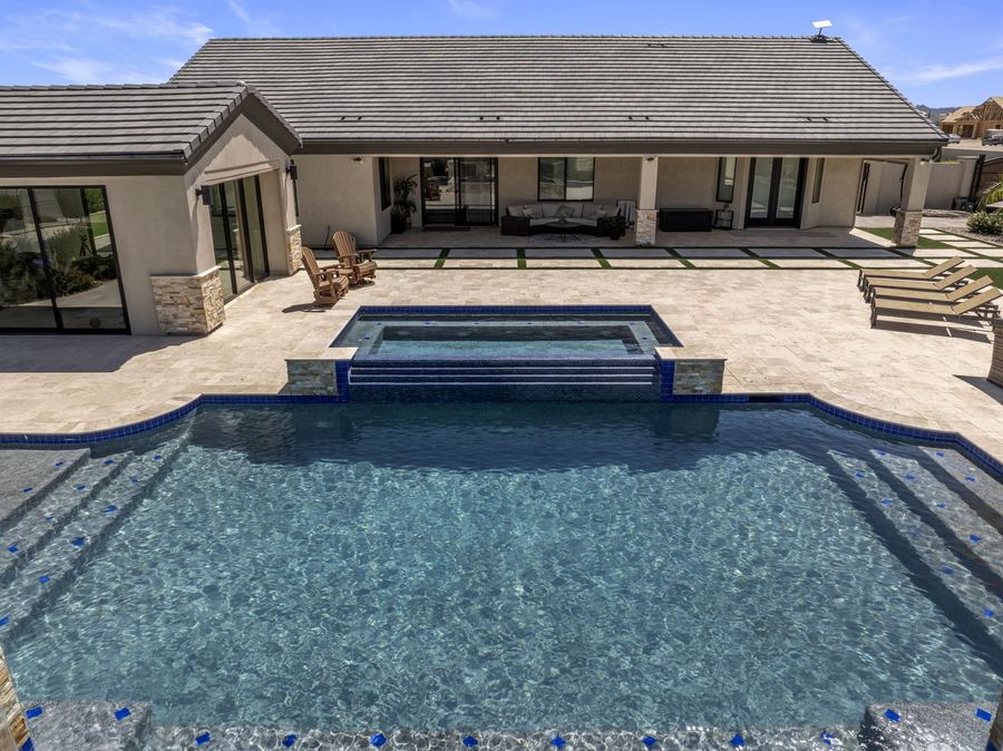 Elevated view of the pool and raised spa facing the covered patio