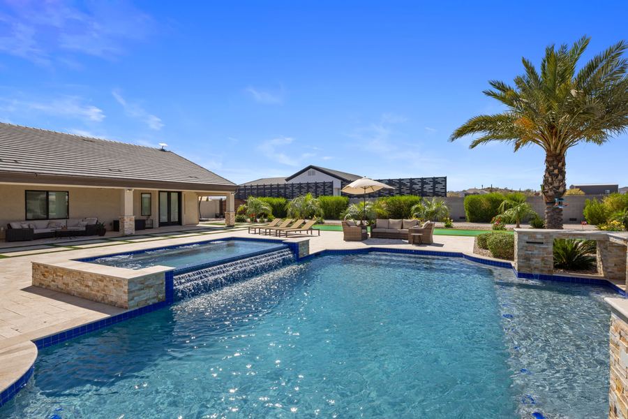 Raised spa spillover and stone wall at the pool edge