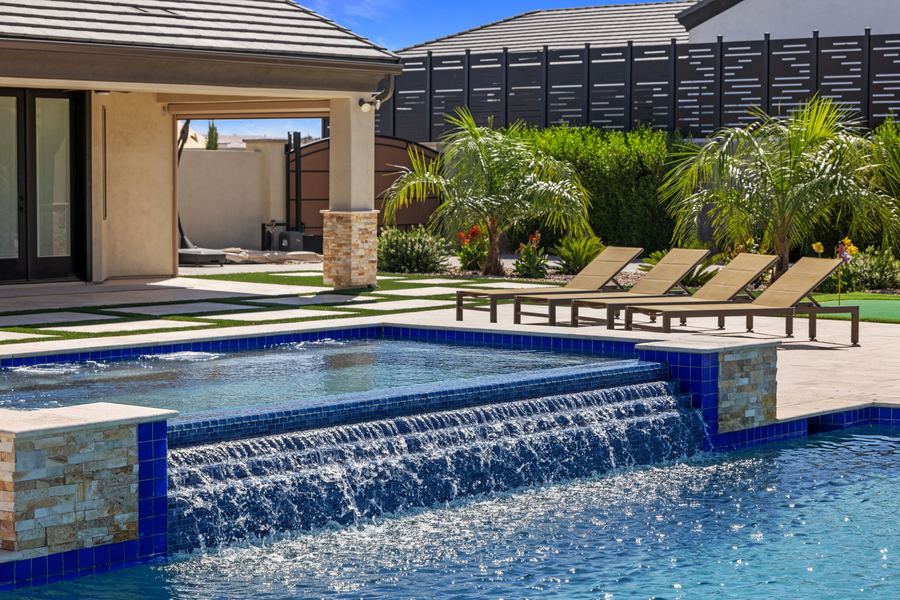 Spa spillover with loungers and palms along the patio