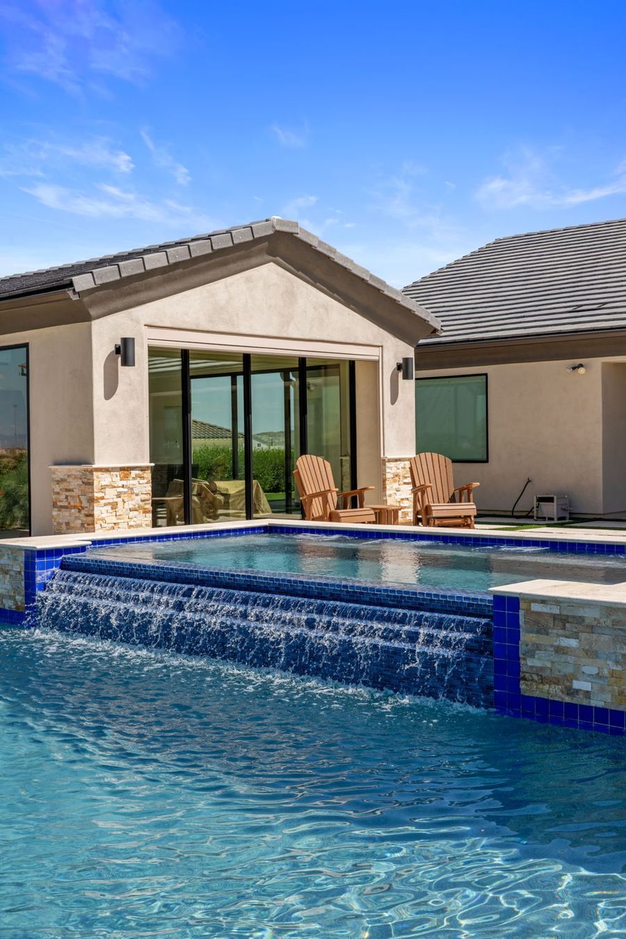 Spa spillover into the pool beside the pool house