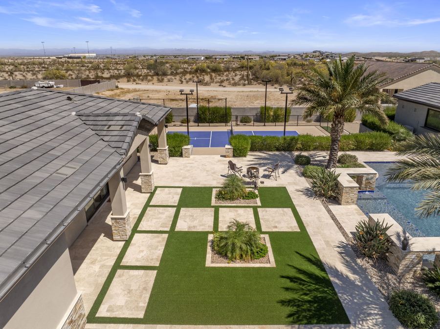 Turf and paver grid courtyard leading to the pickleball court