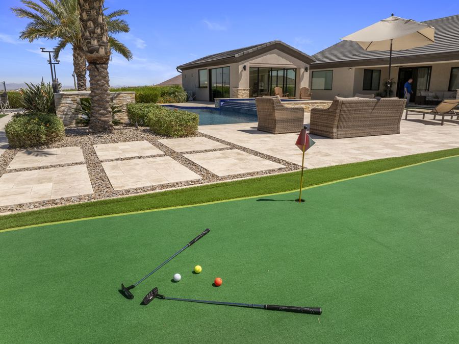 Putting green with clubs and balls near the lounge terrace