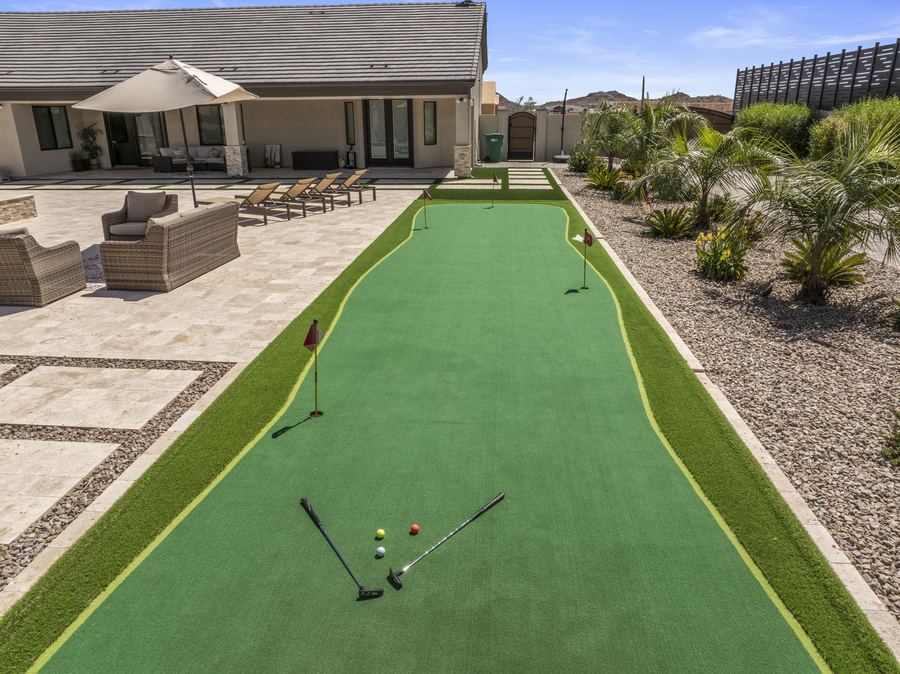 Putting green with clubs leading toward the main house