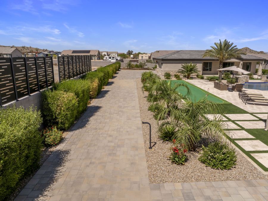 Paver side walk between hedges and turf ribbons