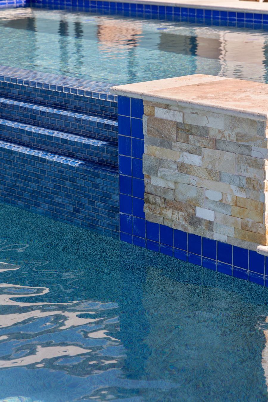 Glass tile and stacked stone at the spa edge
