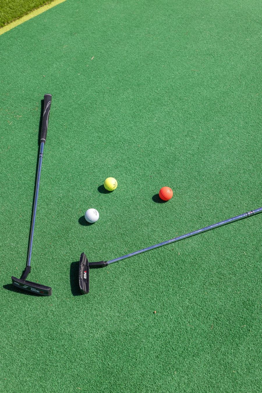 Putters and golf balls on the putting green