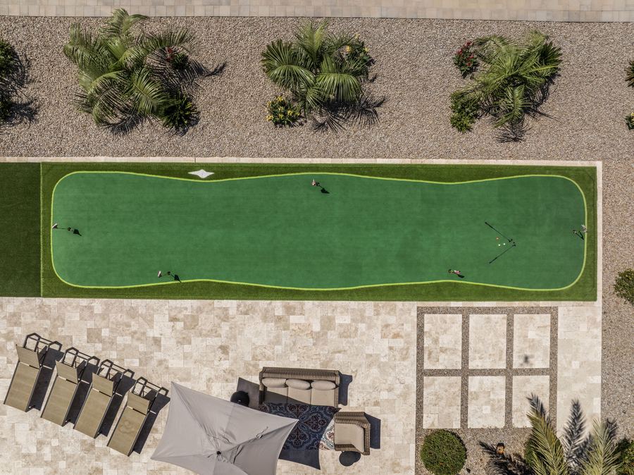 Top-down view of the putting green, loungers and paver grid