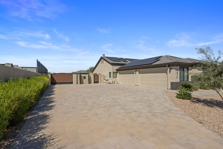Wide paver driveway leading to the garages