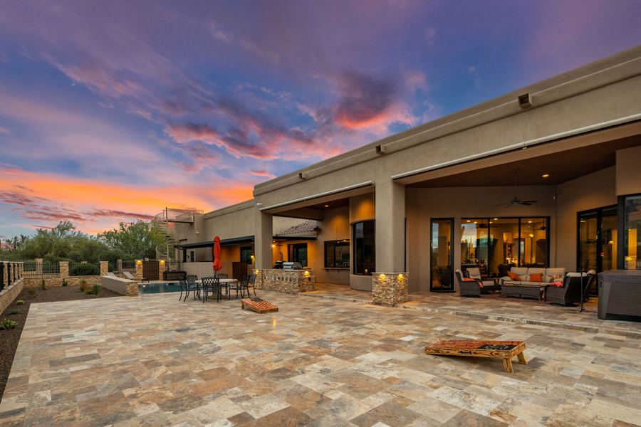 Covered patio and travertine deck at sunset