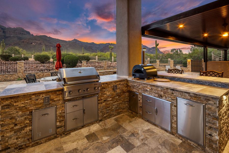 Stacked-stone outdoor kitchen with built-in grill