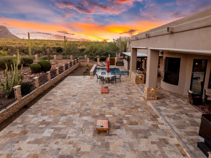 Long travertine patio along the house at sunset
