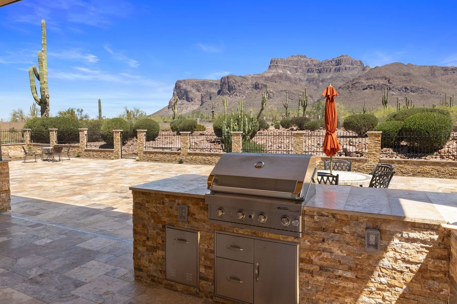 Stacked stone outdoor kitchen with built in grill and mountain view