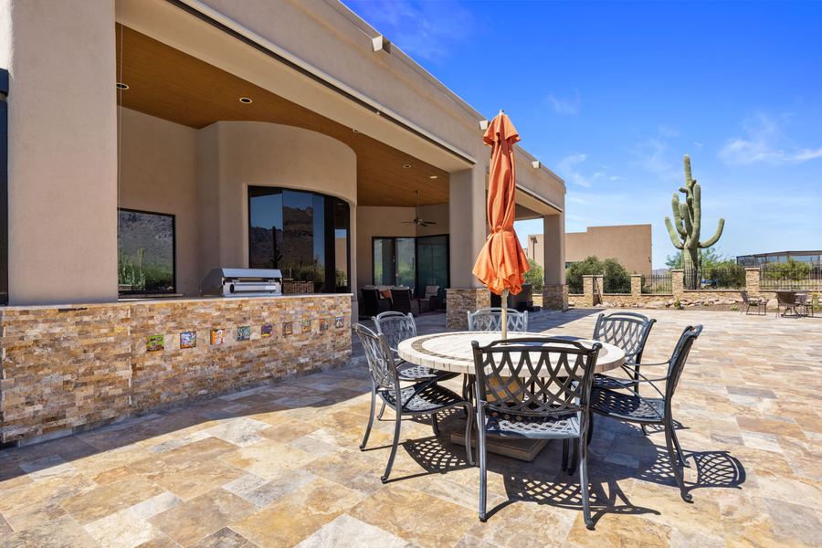 Dining area on travertine next to the outdoor kitchen