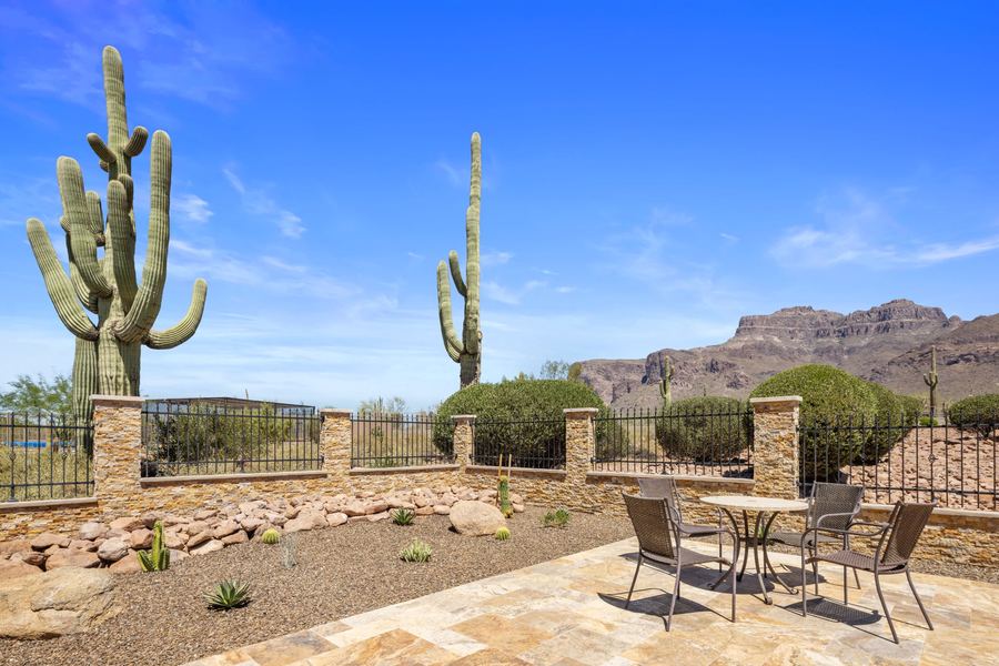 Bistro set on travertine framed by tall saguaros