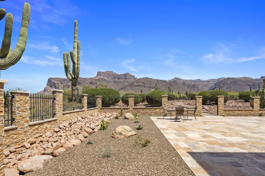 Rock wash and patio edge with mountains beyond the wall