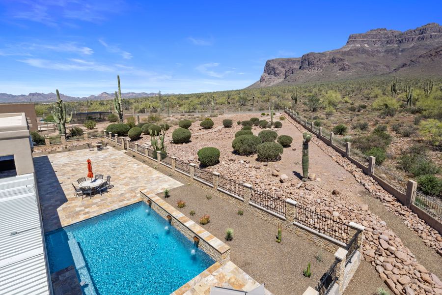 Pool and side yard seen from the rooftop deck with mountains beyond