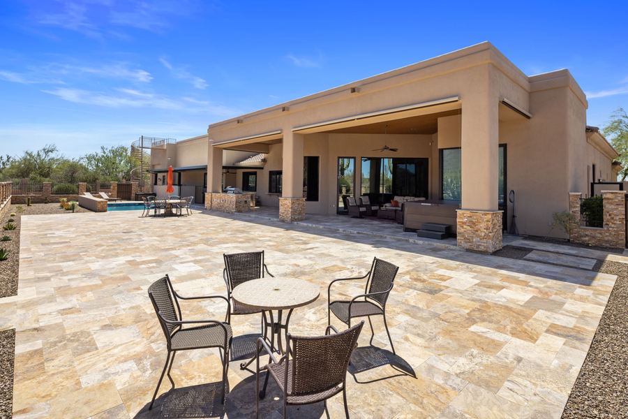 Bistro set on travertine patio facing the back of the house