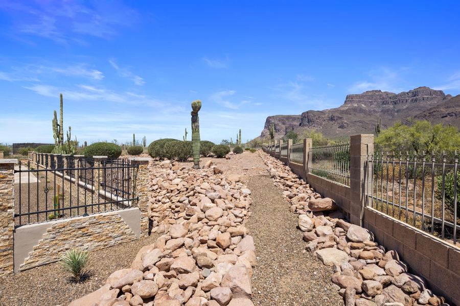 Rock lined path along the perimeter fence