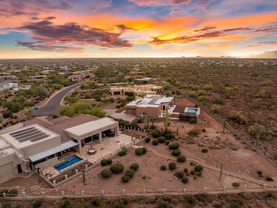 High aerial of the home and pool at sunset