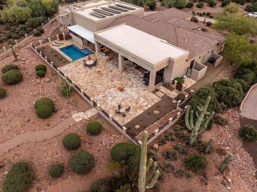 Aerial of the backyard at dusk with saguaros and travertine patio
