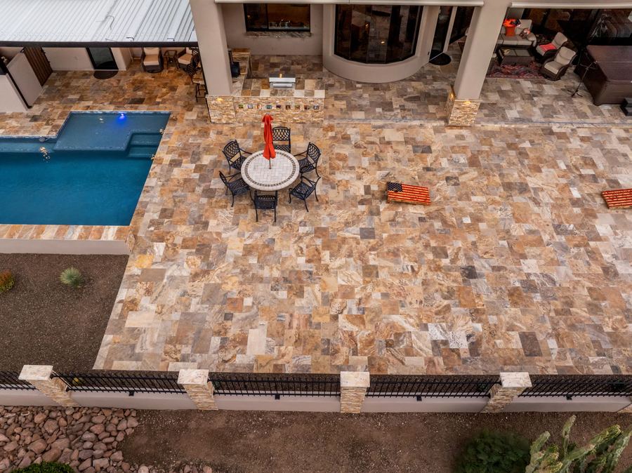 Top down view of the patio dining set and pool edge at dusk