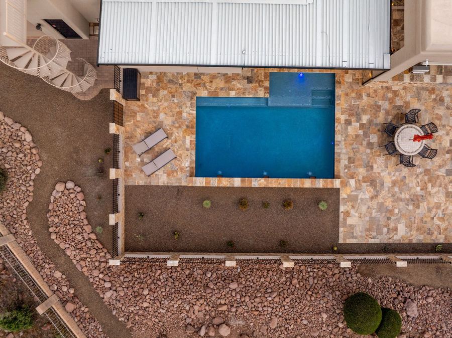 Top down view of the pool and travertine deck at dusk