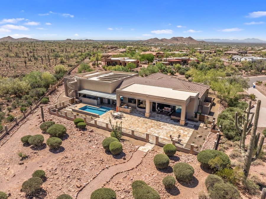 Daytime aerial of the home, pool and patio in the desert