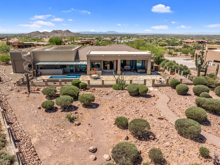 Aerial of the backyard and desert landscaping by day