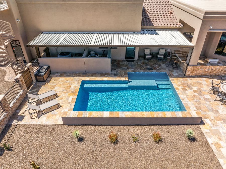 Aerial of the pool with tanning ledge and lounge chairs