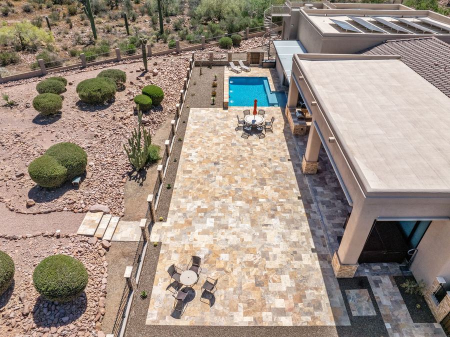 Aerial of the travertine patio and pool beside the house