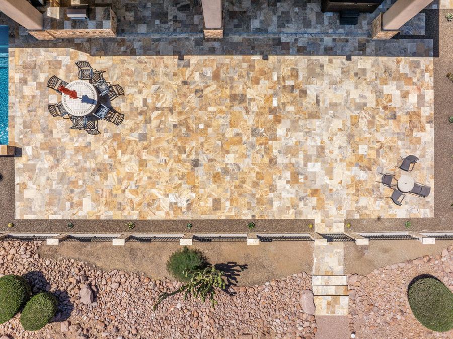 Top down view of the travertine patio with dining sets