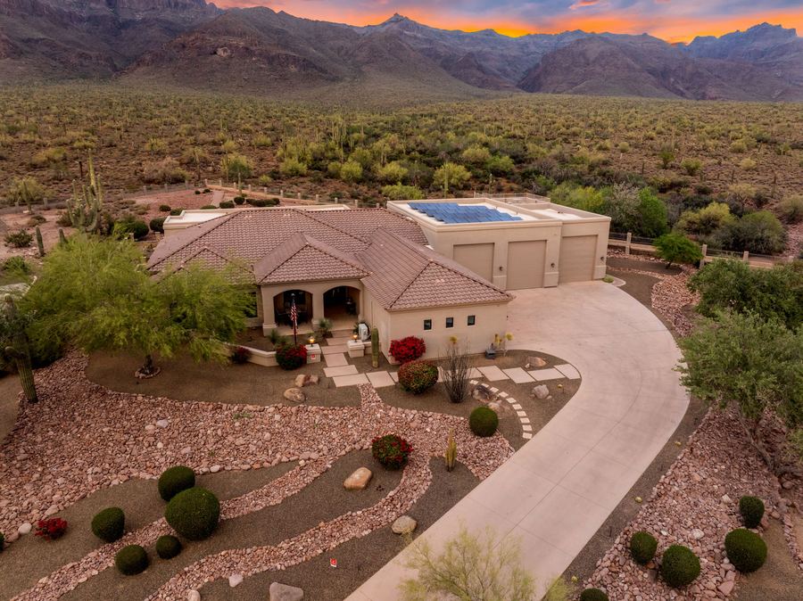 Aerial of the front yard and curved driveway at sunset
