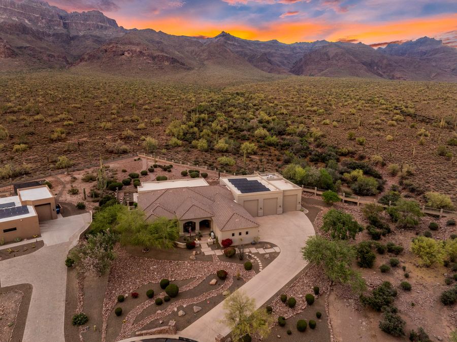 Aerial of the home and front landscaping with mountains at sunset