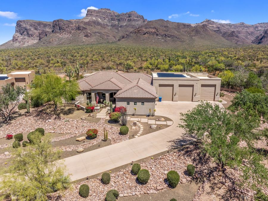 Aerial of the front yard and driveway beneath the mountains
