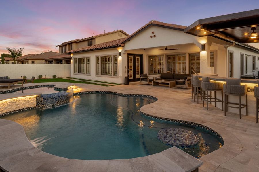 Freeform pool and covered patio at dusk, The Hidden Jewel in Gilbert, AZ