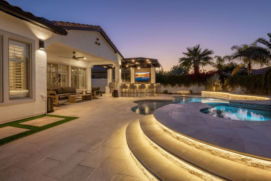Lit step-down pool entry with the covered bar beyond, The Hidden Jewel in Gilbert, AZ