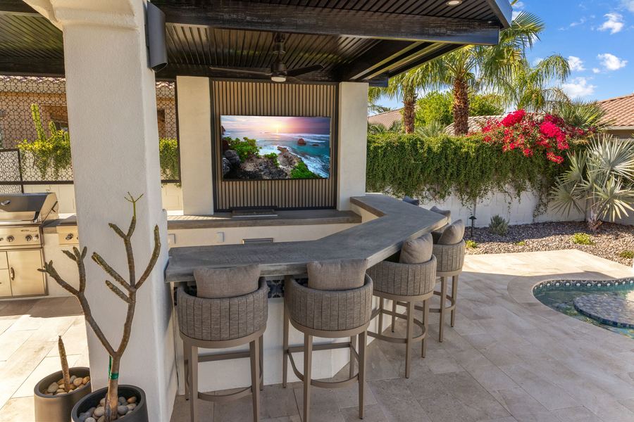 Covered outdoor bar with TV and seating, The Hidden Jewel in Gilbert, AZ