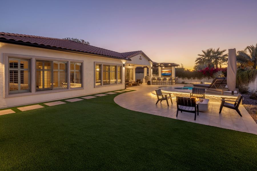 Turf lawn, patio and fire pit seating at twilight