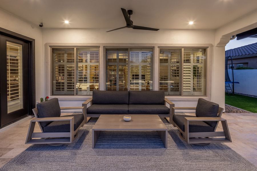 Covered patio lounge set with ceiling fan and lights