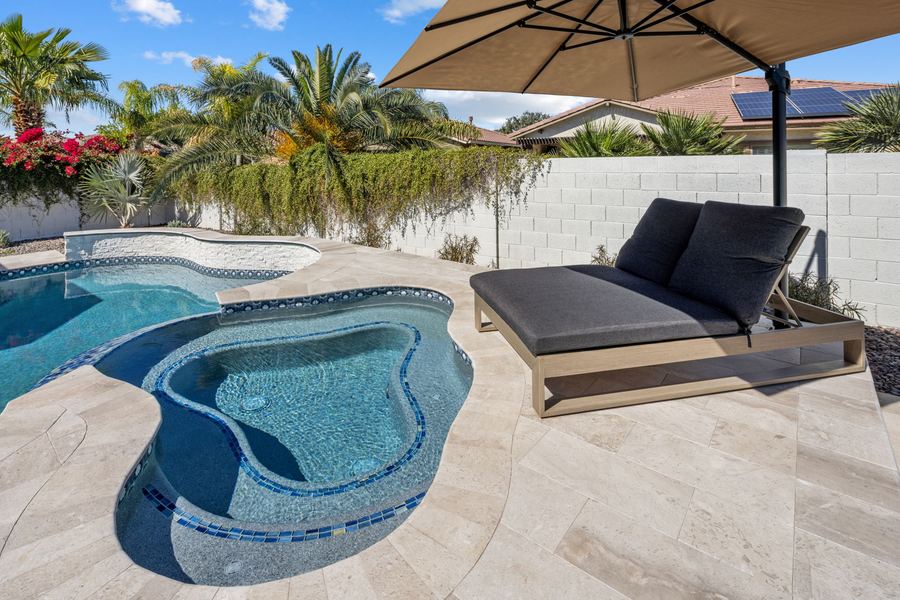 Shallow lounge pool with daybed and shade umbrella