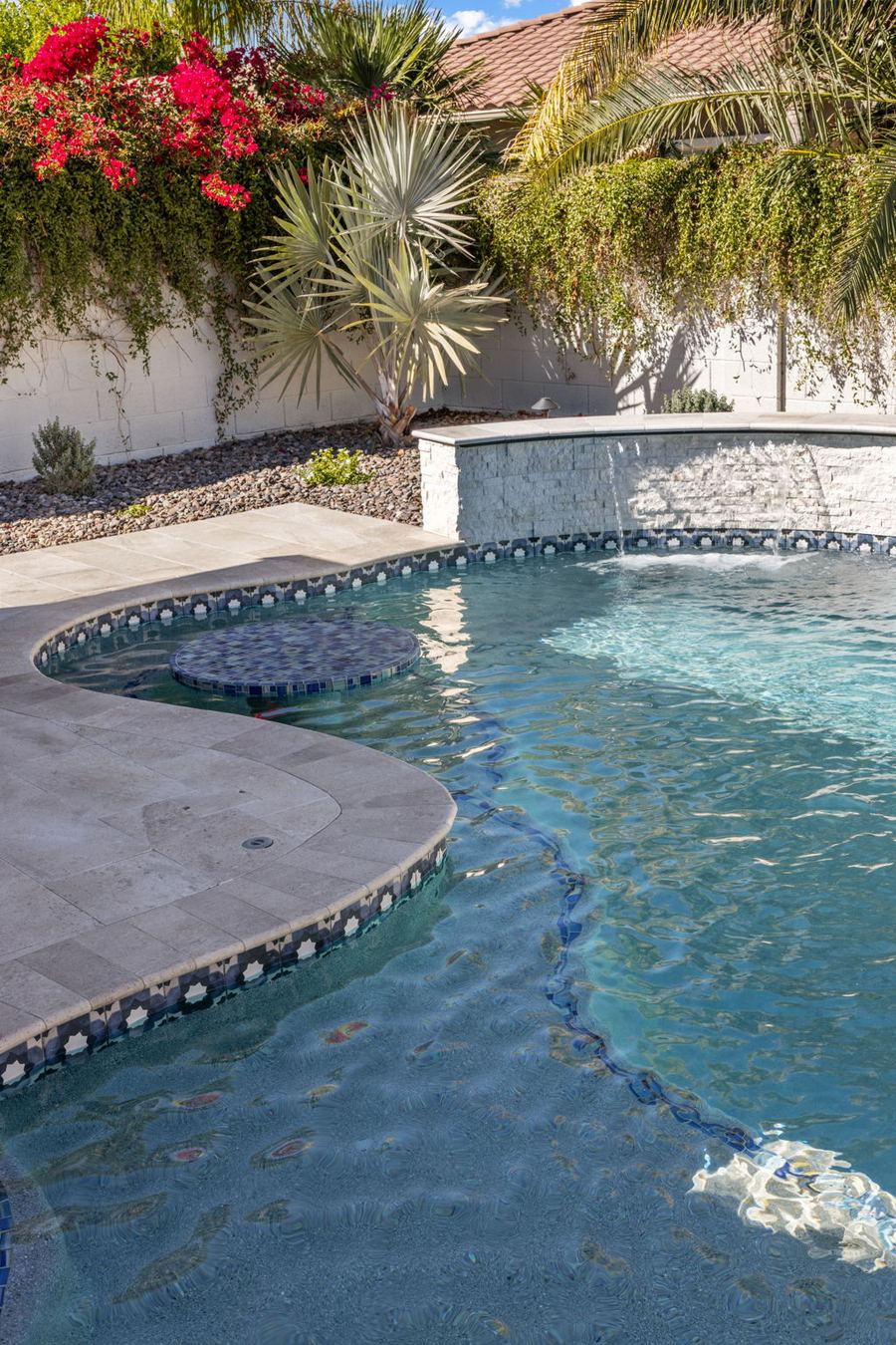Pool lagoon with tiled table, raised spa and bougainvillea