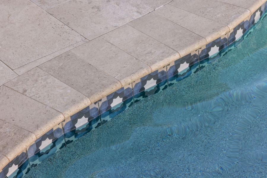 Stone coping and patterned waterline tile detail