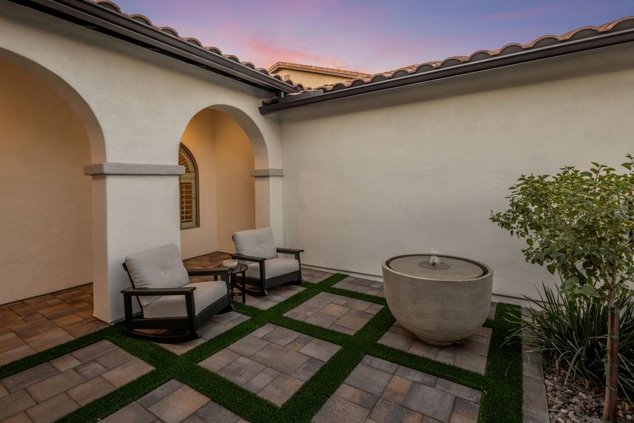 Front courtyard with paver and turf grid, seating and fountain