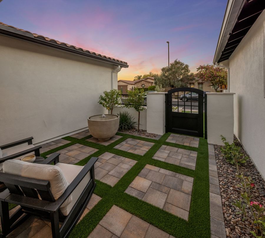 Courtyard seating with paver and turf grid by the iron gate