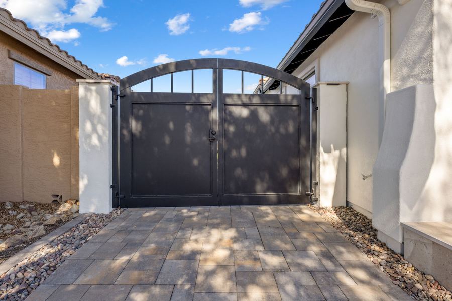 Dark double side gate with paver driveway